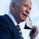 President Joe Biden removes a high-quality mask before speaking at the Atlanta University Center Consortium in Atlanta, Georgia on January 11, 2022.